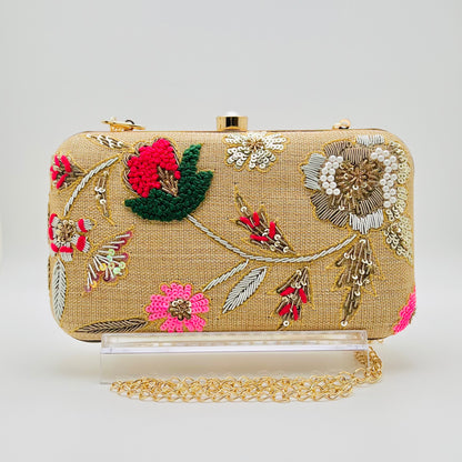 Zardozi and Dabka hand work classic clutch in gold dust color. The bag also features a detachable chain so that it can be worn on the shoulder as a sling.