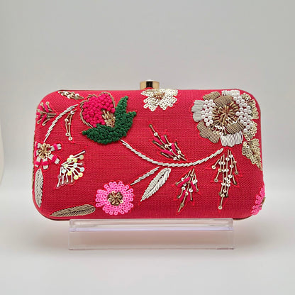 Zardozi and Dabka hand work classic clutch in Ruby red color. The bag also features a detachable chain so that it can be worn on the shoulder as a sling.